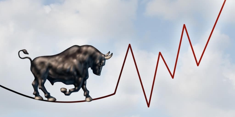 Bull market risk financial concept as a heavy bullish beast walking on a high tightrope shaped as a stock market profit chart representing the investment danger ahead.