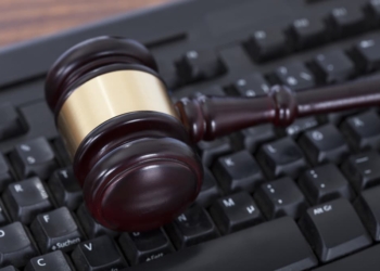 Closeup of mallet on computer keyboard in courtroom