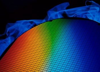 detail of a silicon chip wafer reflecting different colors