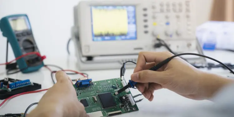 Technician checks the electronic device. Printed circuit board for the robot.