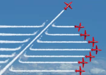 Game changer business or political change concept and disruptive innovation symbol and be an independent thinker with new industry ideas as an individual jet breaking through a group of airplane smoke as a metaphor for defiant leadership.