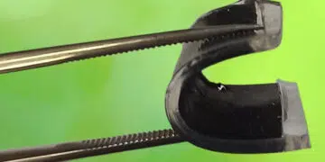 Tongs bending a flexible supercapacitor into a U shape. Credit: University of Surrey