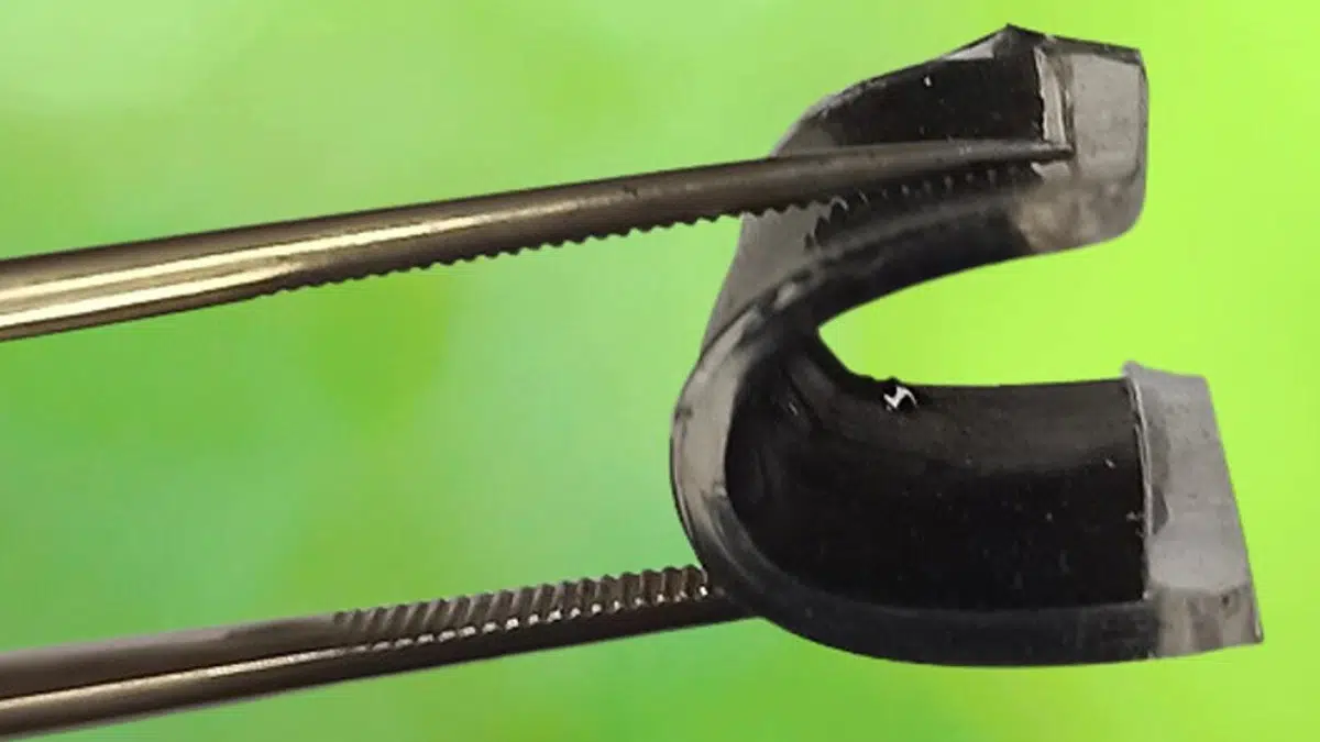 Tongs bending a flexible supercapacitor into a U shape. Credit: University of Surrey